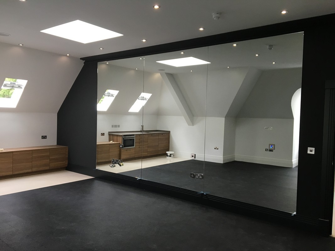 Frameless glass wall dividing loft conversion in Camden Town