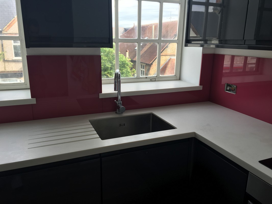 Deep plum coloured glass splashback in modern Camden Town kitchen