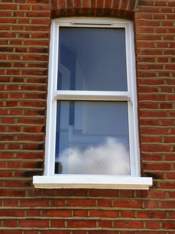 uPVC sash window on Victorian red brick house in Camden Town
